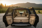 Beige inflatable car bed with two pillows installed in a car during a road trip
