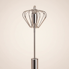 Close-up of stainless steel hand-push rotary whisk mechanism