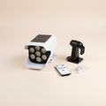Solar sensor light with remote and mounting accessories on a studio background