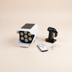 Solar sensor light with remote and mounting accessories on a studio background