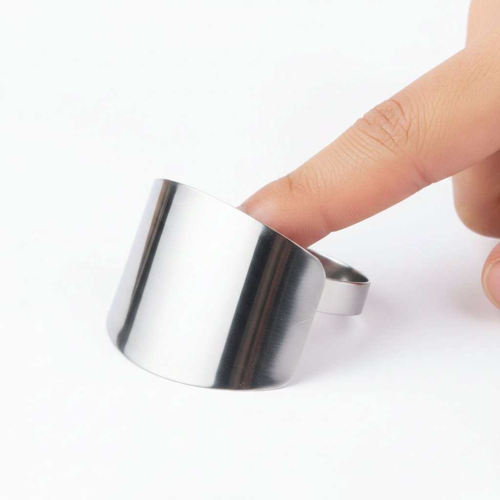 Close-up of the curved polished stainless steel finger guard
